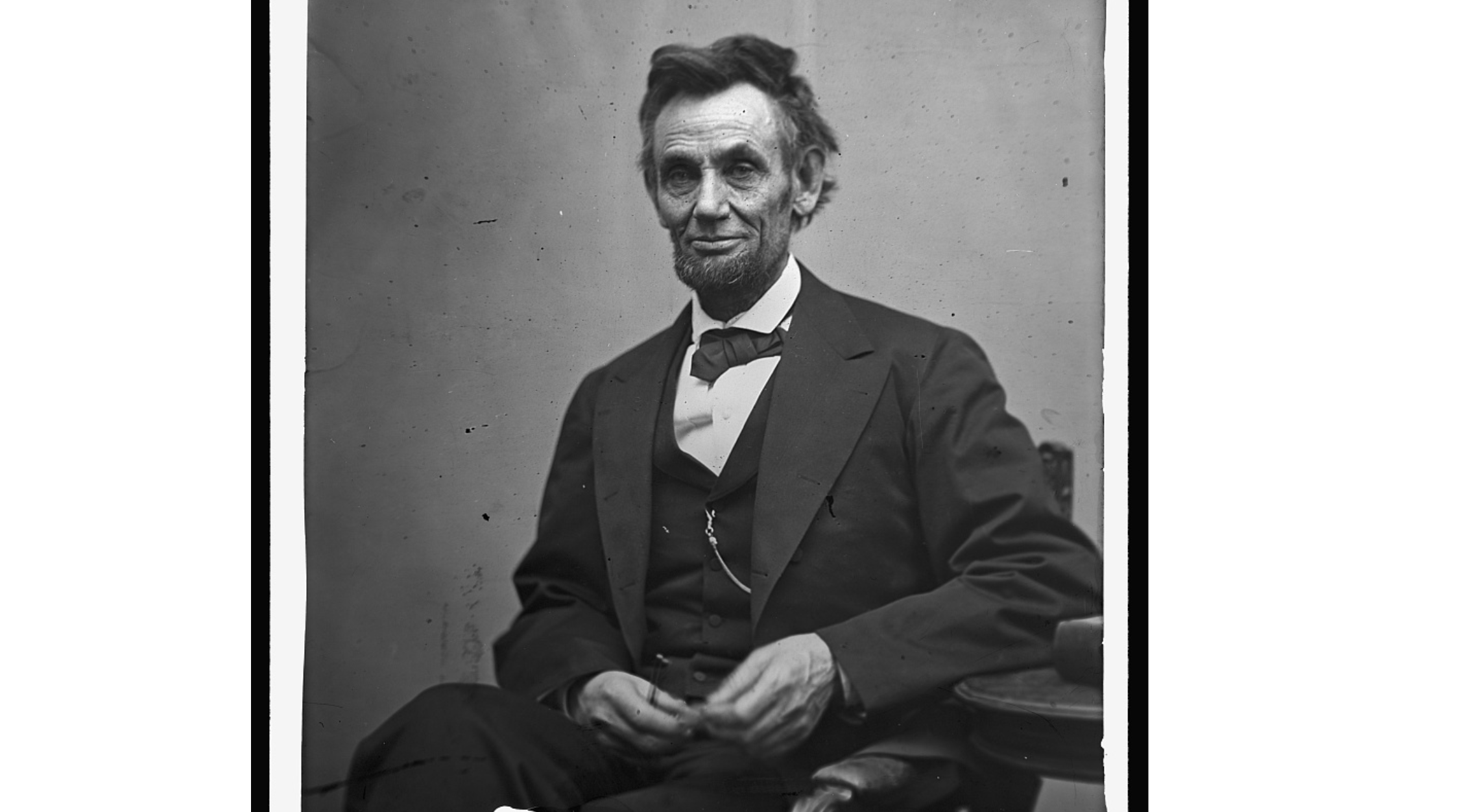 Abraham Lincoln seated holding pencii & glasses 1865 Abraham Lincoln
