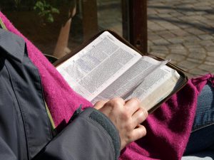 Bible being read.