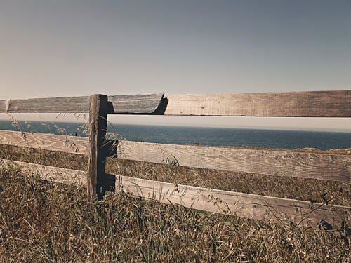 sea-ocean-meadow-fence Overcoming obstacles to the wide expanse of God's love.